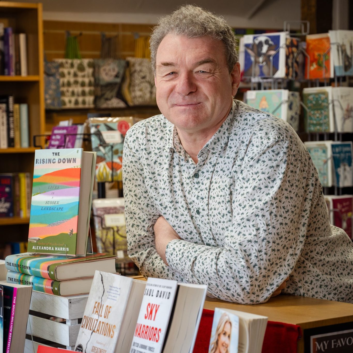 Owner James Doyle in The Crow Road looking over a display of books